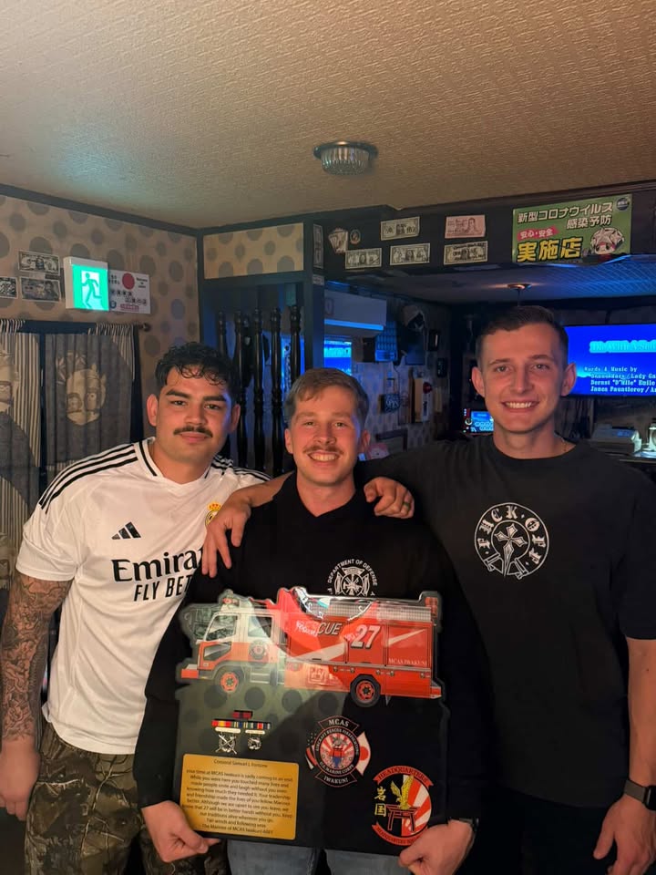 Three customers with a custom fire-truck plaque and awards