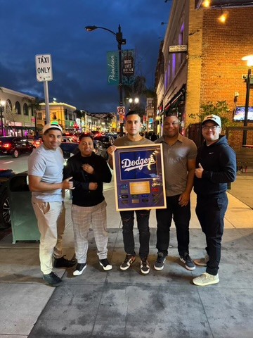 Customer group holding a Dodgers jersey shadow box
