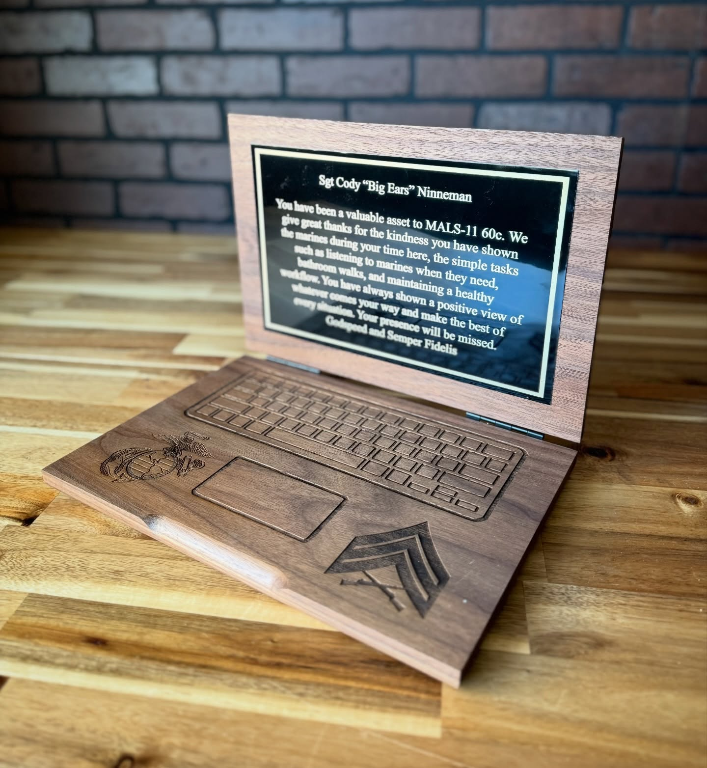Engraved wooden laptop award with a keyboard, insignia, and a personalized message