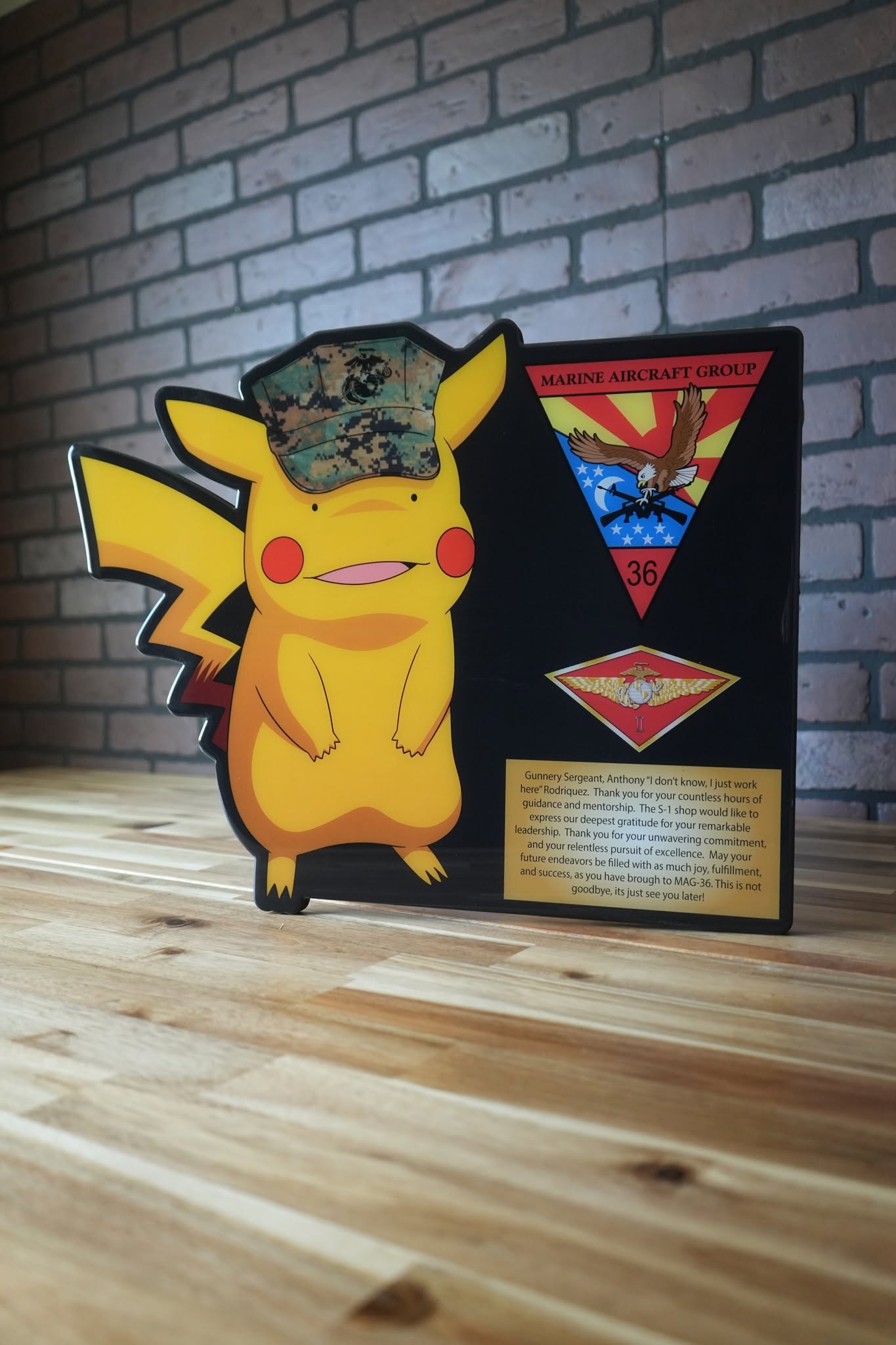 Pikachu character plaque with a Marine cap, unit logos, and a gold message plate