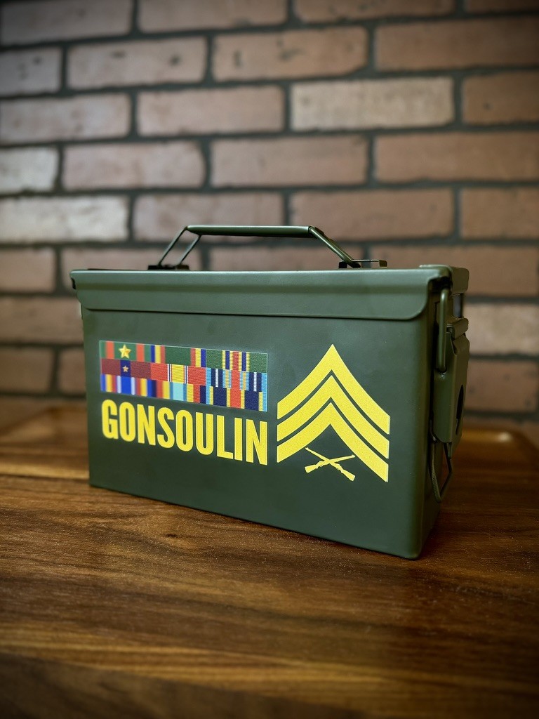 Personalized green ammunition box with a name, military ribbons, and rank design