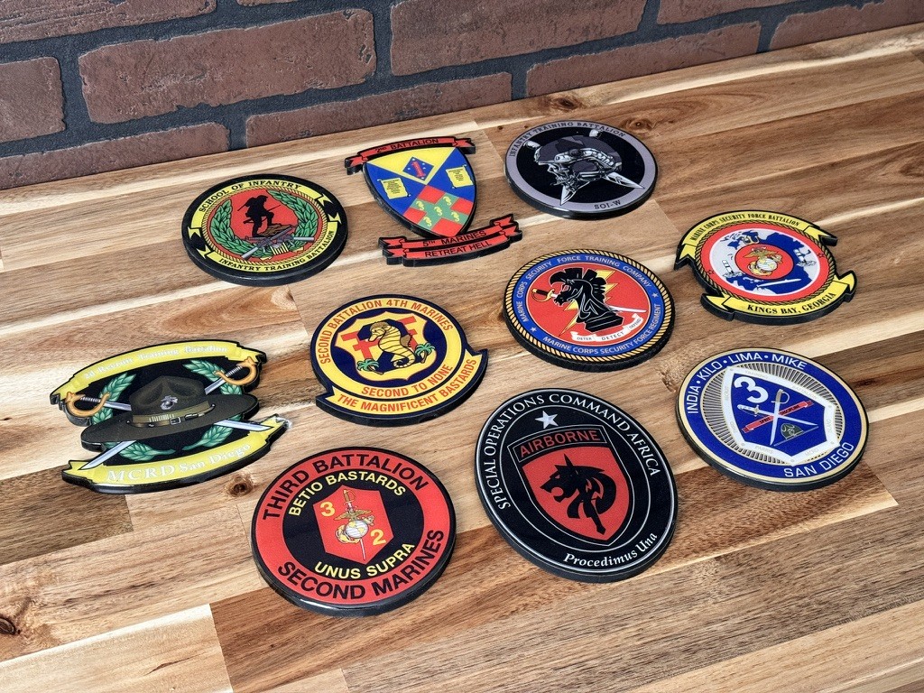 Colorful military unit wooden patch decals arranged on a tabletop