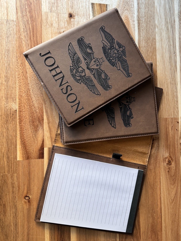 Personalized brown padfolios with engraved names and military insignia