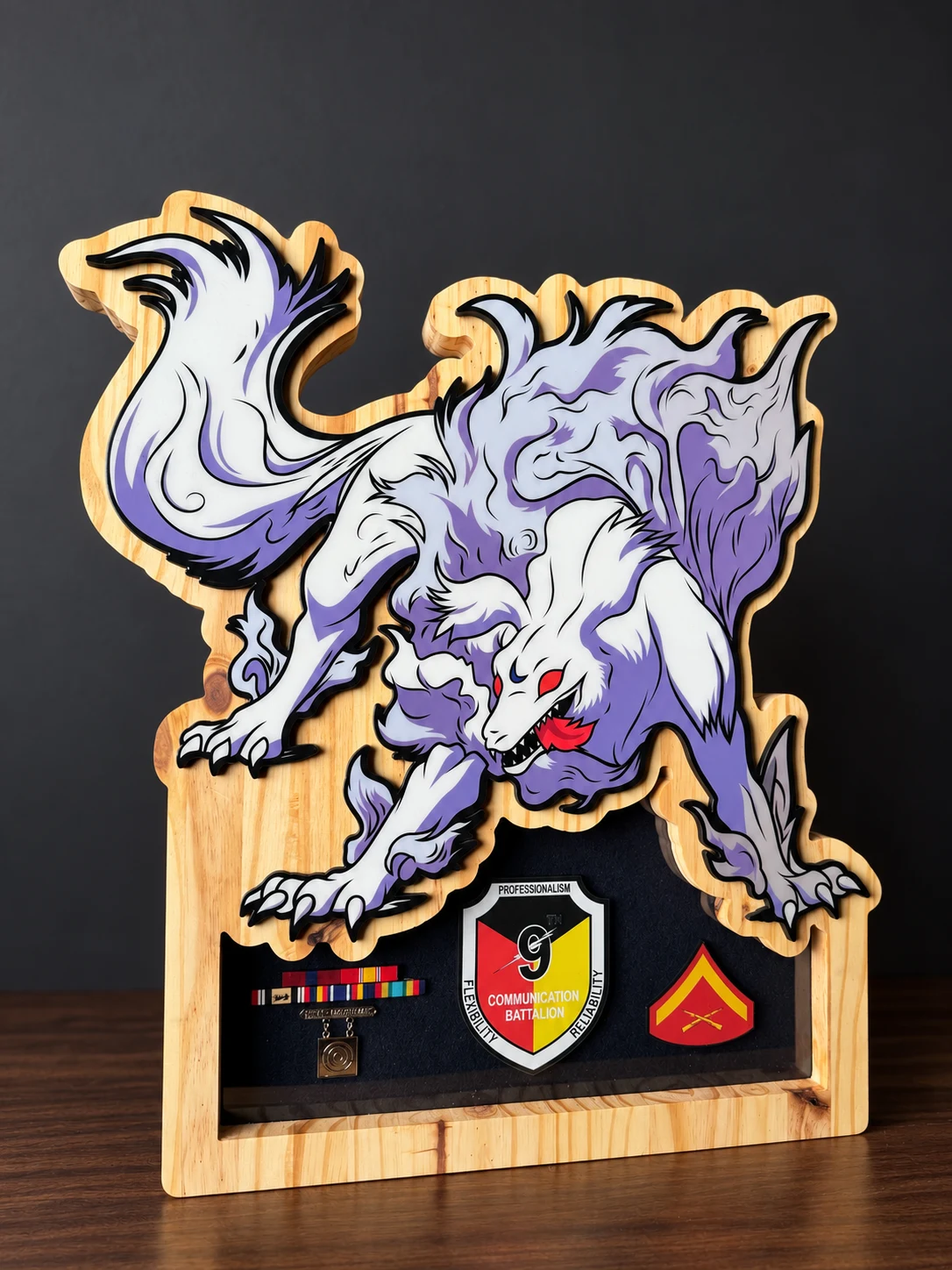 White and purple wolf shadow box with a 9th Communication Battalion emblem, ribbons and rank insignia