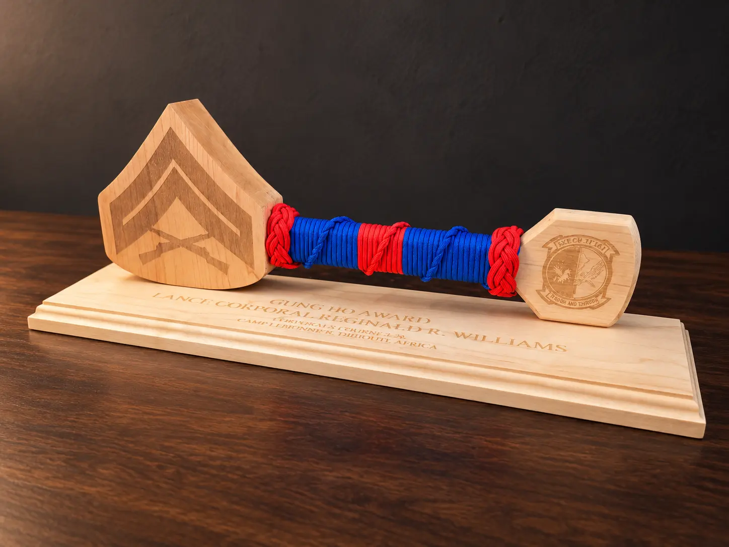 Marine Corps rank hammer on an engraved wood base with blue cord, a red center stripe and red braided knots